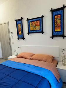 a bedroom with a bed with two stained glass windows at Casina Viareggina 2 camere in Viareggio