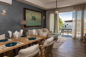 a dining room with a table and a couch at Summer beachfront apartment in Belle Mare