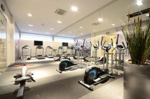 a gym with several treadmills and exercise bikes at Dom & House - Old Town Tandeta in Gdańsk