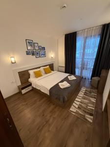 a bedroom with a bed and a large window at From Sunrise to Sunset at Oak Residence Smolyan in Smolyan