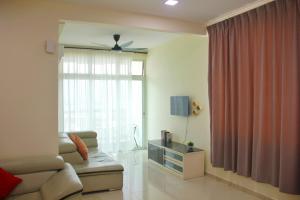 een woonkamer met een bank en een raam bij Classic Spot - Meru Raya in Ipoh