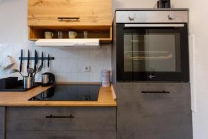 a kitchen with a sink and a stove top oven at Macabu Apartment Linda in Chemnitz +4 photos