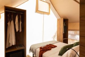 a bedroom with a bed and a closet at wecamp Cádiz in Cádiz