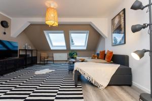 a living room with a couch and a table at Macabu Apartment Linda in Chemnitz