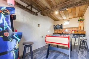 a kitchen with a red and white counter and stools at Le refuge de l hortensia gite in Juaye-Mondaye