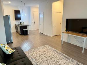 a living room with a couch and a flat screen tv at Charming 1BR Getaway, Leander TX in Leander
