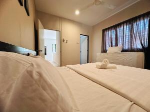 ein Schlafzimmer mit zwei Betten und einem Fenster in der Unterkunft New Island Luxe Retreat Vacation Home 14pax Nearby Gurney in Tanjung Bungah