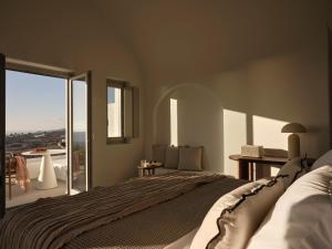 a bedroom with a large bed and a large window at Ark in Pirgos