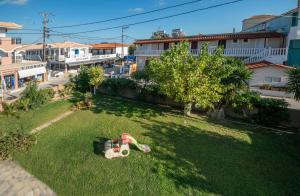 a toy train sitting on the grass in a yard at Anadiomeni Pool & Beach Apartments by "elite" in Zakynthos