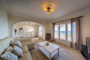 a living room with a couch and a table at San Jaime View - stunning sea views close to resort in Son Bou
