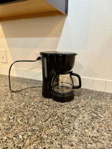 a black coffee maker sitting on a counter at Peaceful 1BR Stay Leander TX near Austin in Leander