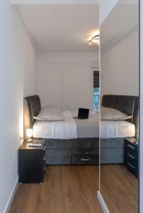 a bedroom with a large bed and a mirror at Beautiful Villa Aria in Zadar +17 photos