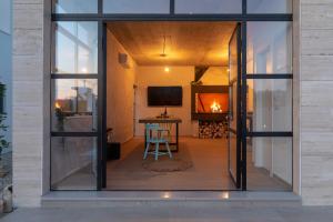 a glass door leading into a room with a table at Beautiful Villa Aria in Zadar