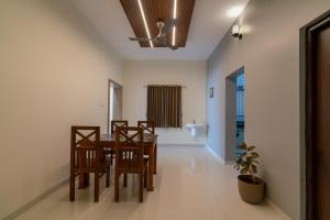 a dining room with a table and chairs at THE SURRYA MAX RESIDENCY in Pollāchi