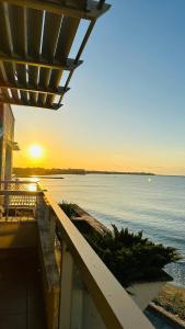 a view of the ocean at sunset from a building at Apartments Helios in Pomorie