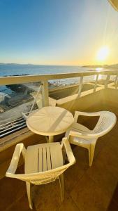 a balcony with a table and chairs and the ocean at Apartments Helios in Pomorie