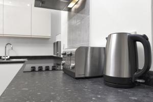 a coffee maker sitting on a counter in a kitchen at Central Baxter Park Apt ! Free WiFi ! Sleeps 6 in Dundee