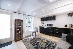 a kitchen with black cabinets and a table at MHL - Maison Hotel Lyon in Lyon