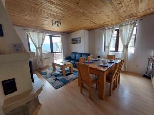 a living room with a table and a couch at Pamporovo Rhodopi Pearl Apartments - Private Apartments in Pamporovo