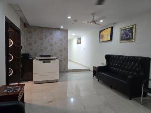 a waiting room with a couch and a table at Hotel Jubilee Pride in Hyderabad