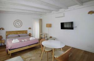 a bedroom with a bed and a table and a tv at Old Bakery Rome GuestHouse in Rome