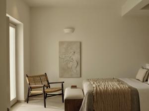 a bedroom with a bed and a chair at Ark in Pirgos