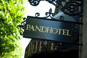 a sign that reads pandhibited hanging on a building at The Pand Hotel - Small Luxury Hotels of the World in Bruges