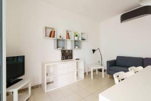 a living room with a couch and a television at Vista Mare Paradiso by Salento Prime in Torre Vado