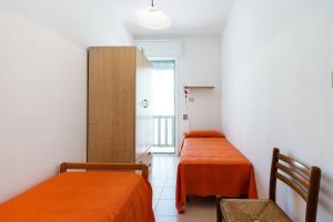 a small room with two beds and a cabinet at Vista Mare Paradiso by Salento Prime in Torre Vado