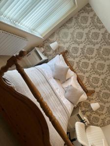 a bedroom with a bed and a window and a chair at Cosy 2 Bed House near Birmingham Airport & NEC in Birmingham