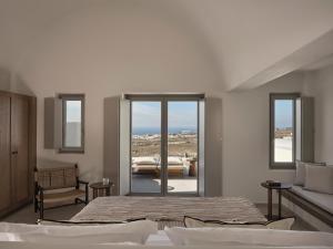 a bedroom with a bed and a view of the ocean at Ark in Pirgos