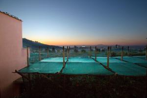 a swimming pool with the sunset in the background at Il Pozzillo Maison in Massa Lubrense