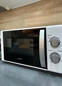 a microwave oven sitting on top of a counter at So Good Studio in Onești