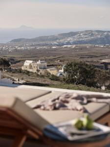 a book on a table with a view of a field at Ark in Pirgos