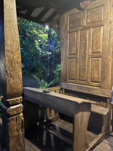 a wooden room with a window and a bench at Sang Natha Lodge - Kopi Tiam & Agro in Tjatur