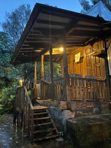 a wooden cabin with a bench in front of it at Sang Natha Lodge - Kopi Tiam & Agro in Tjatur +127 photos