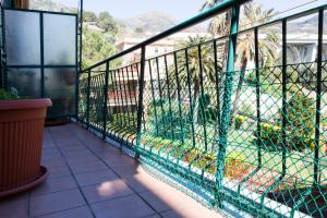 a balcony with a green fence and a yard at Casa Europa - Arenzanohost in Arenzano