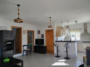 a room with a kitchen and a living room at Casa rural Los Rosales in Lanjarón +23 photos