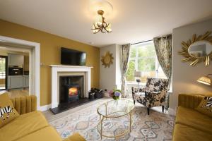 a living room with a couch and a fireplace at Garden Cottage in Inverness