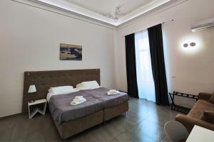A bed or beds in a room at Home De Curtis