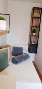 a bedroom with a bed with a blue pillow on it at Apartment JASS next to MALL OF SPLIT in Split