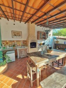 a kitchen with a large wooden table in a room at Gambá Casa Boutique in Búzios