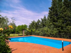 a large blue swimming pool in a yard at Tuscany Roses in Arezzo