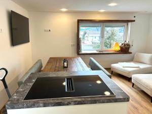 a living room with a table and a couch at Alpen Erlebnis Oberstaufen in Oberstaufen