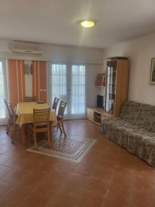 a living room with a table and a couch at Apartments Mimoza in Slano