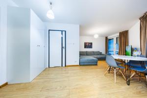 a living room with a table and a couch at Apartamenty Zamkowe- High Standard Apartment City Center by StayNest in Rzeszów