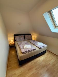 a small bedroom with a bed in a attic at Anita Apartments in Flattach