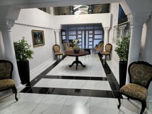 aoyer with a black and white floor and a table and chairs at Sixty On Whales in Gqeberha