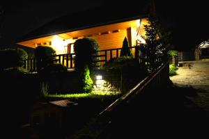 クリニツァ・ズドルイにあるAlpejskie Domy Ski Houseの塀で夜灯が灯る家
