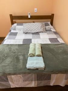 a bedroom with two beds with towels on them at Casa Maria Alice in Manhã